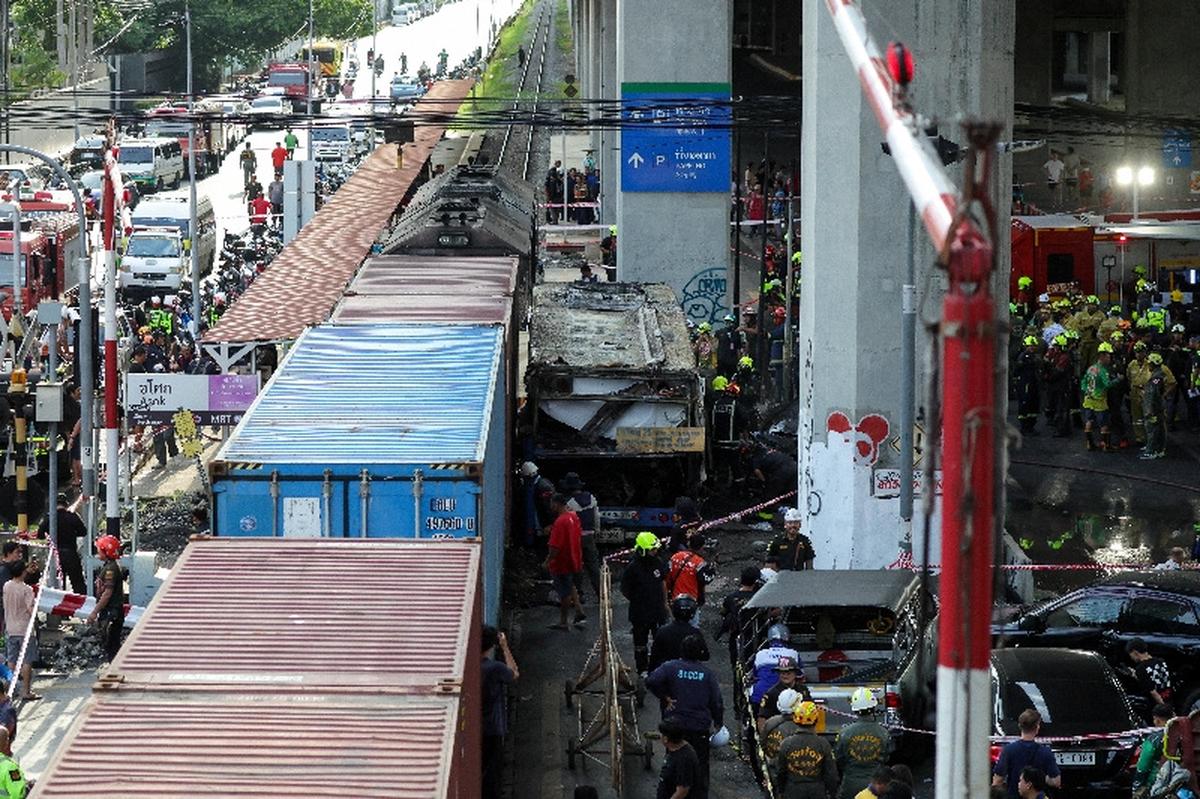 Emergency services work at a site where a train collided with a bus and several cars on Asok-Din Daeng Road, causing several casualties, in Bangkok, Thailand, May 16, 2026. REUTERS/Athit Perawongmetha