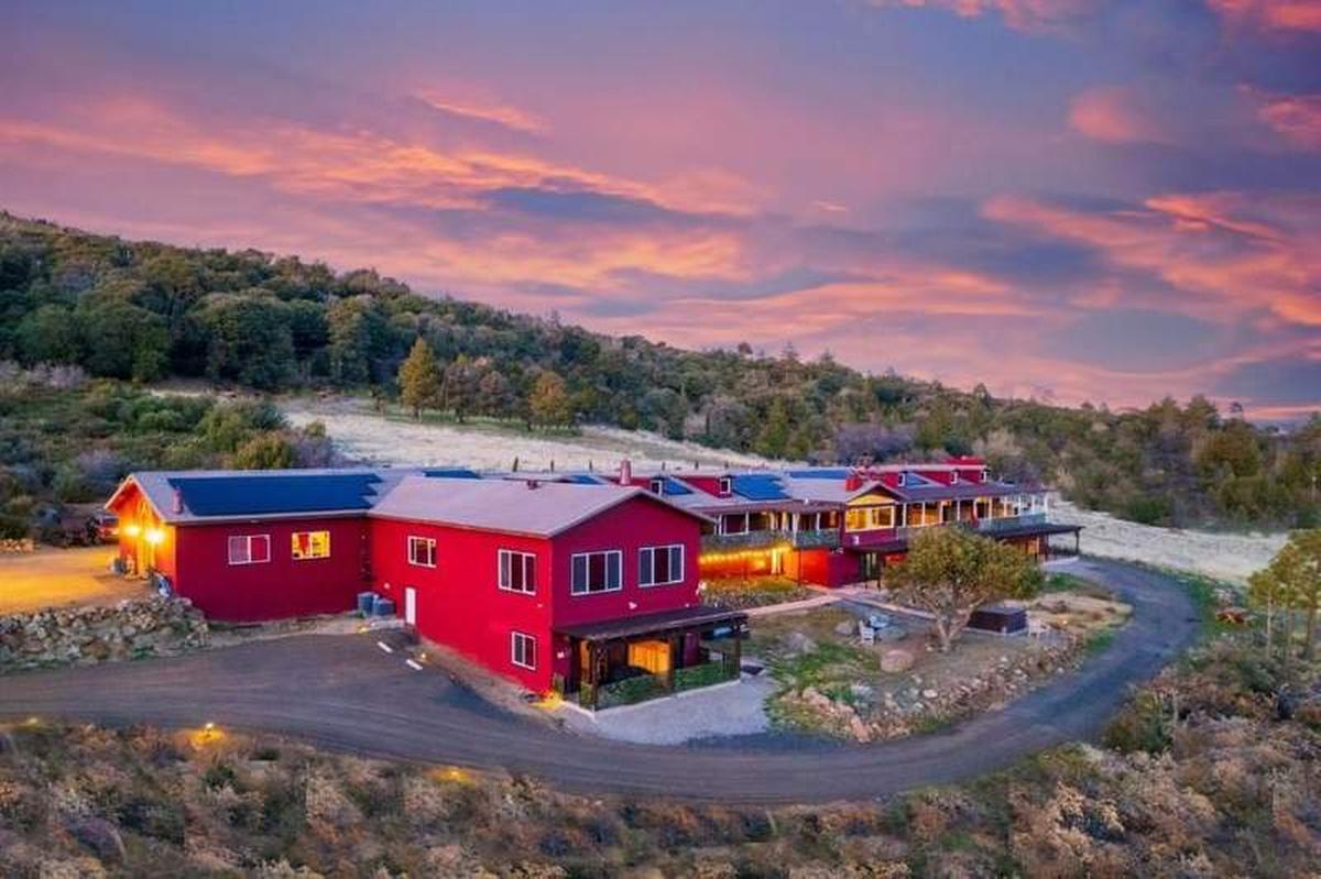  Full view of Quiet Mind Retreat red buildings in the mountains. Photo credit: Quiet Mind Retreat 