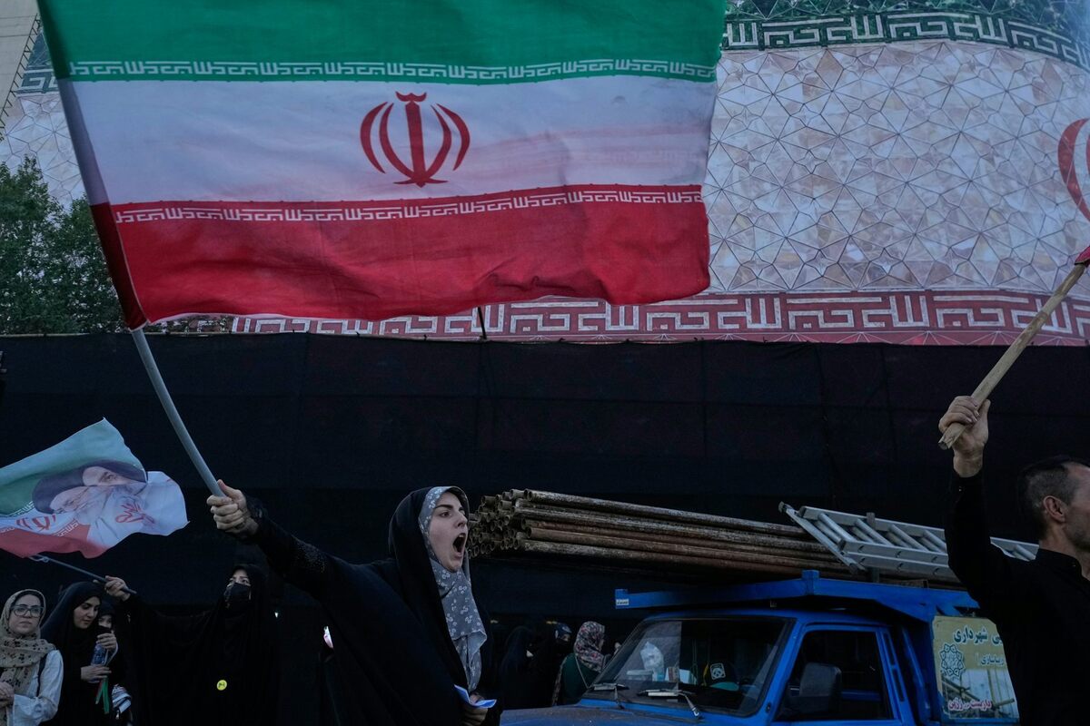  A woman waves an Iranian flag in Islamic Revolution Square in Tehran, Iran, on June 14, 2026. AP Photo/Vahid Salemi 