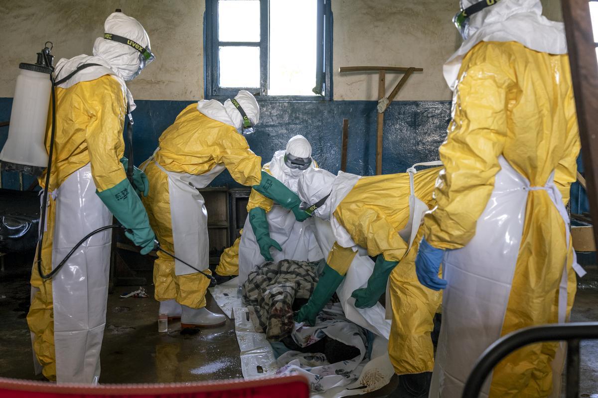 The body of Bahati Ibiliabo, 22, who arrived only the previous day, is disinfected after his death at a hospital's Ebola ward in the mining town of Mongbwalu, Democratic Republic of Congo, May 25, 2026. In a remote gold mining town at the epicenter of the Ebola outbreak, medical workers struggle to beat back a surge of deaths and infections. (Arlette Bashizi/The New York Times)