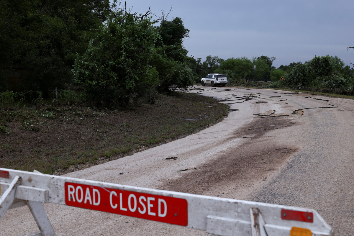 A road is closed after being washed away by the rising Pedernales River following heavy rains and severe weather near Fredericksburg, Texas, U.S., July 16, 2026. REUTERS/Kaylee Greenlee