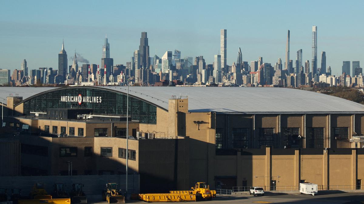 FILE PHOTO: The Manhattan skyline is seen behind the American Airlines hangar at the LaGuardia Airport in New York City, U.S., November 18, 2025. REUTERS/Kylie Cooper/File Photo