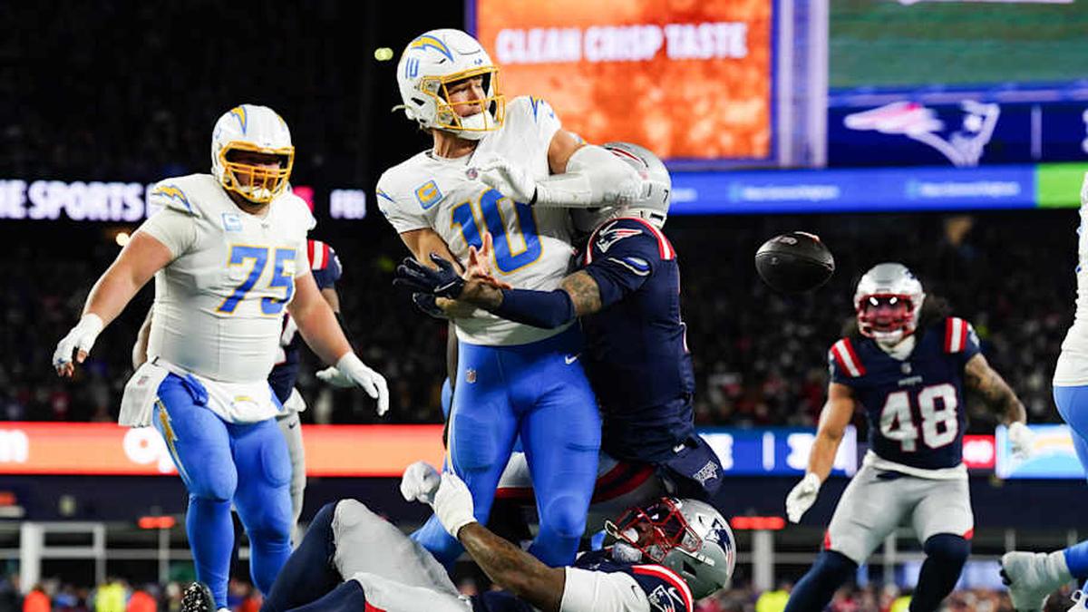  Jan 11, 2026; Foxborough, MA, USA; Los Angeles Chargers quarterback Justin Herbert (10) throws the ball away to avoid a sack during the second quarter against the New England Patriots in an AFC Wild Card Round game at Gillette Stadium. Mandatory Credit: David Butler II-Imagn Images | David Butler II-Imagn Images 