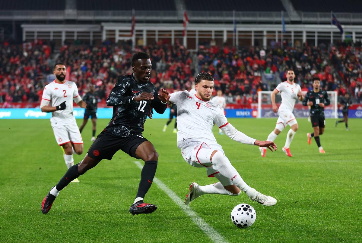  Tani Oluwaseyi #12 of Canada and Omar Rekik #4 of Tunisia battle for the ball during an International Friendly at BMO Field on March 31, 2026 in Toronto, Ontario, Canada. (Photo by Vaughn Ridley/Getty Images) Photo by Vaughn Ridley/Getty Images