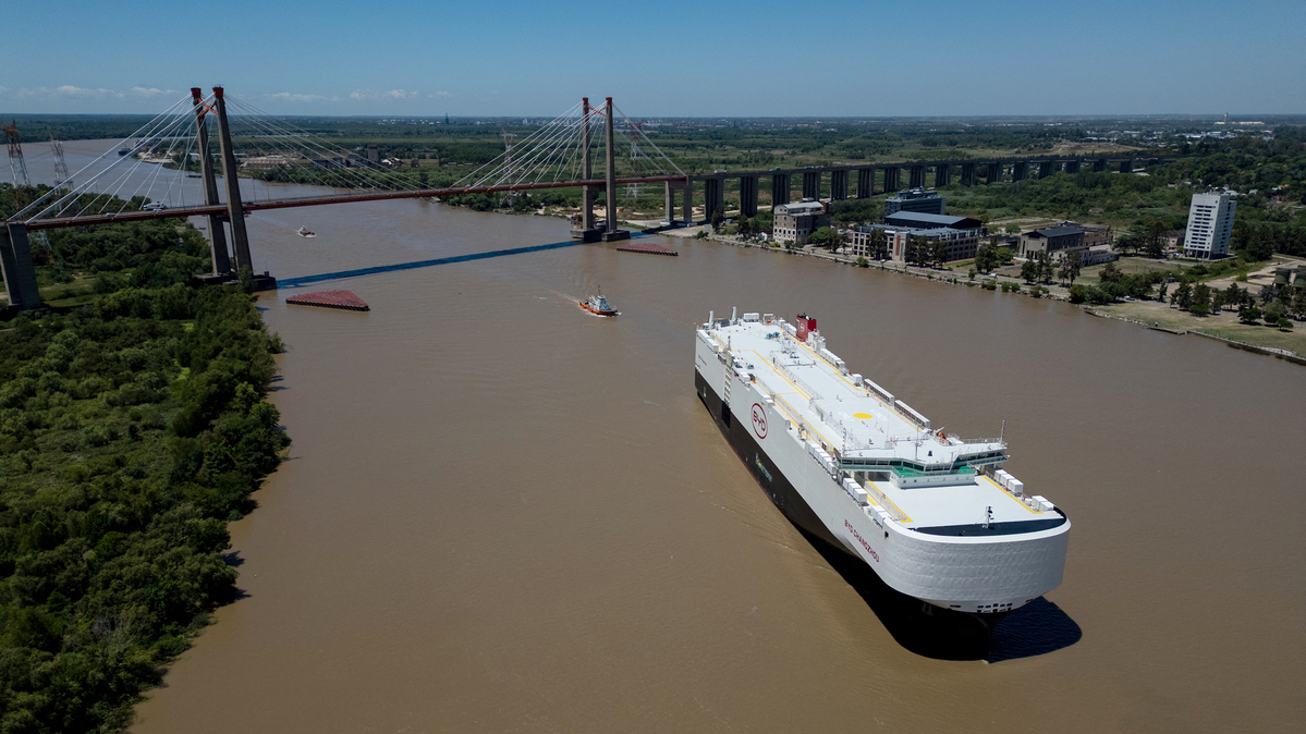 The BYD Changzhou ship sails transporting new cars on the Parana River, heading to the Zarate Port in Zarate, Buenos Aires Province, Argentina on Jan. 19, 2026. Chinese auto manufacturer BYD unloaded around 5,000 new vehicles, including electric and hybrid models, to the Argentine market. (Tomas Cuesta/AFP/Getty Images/TNS)