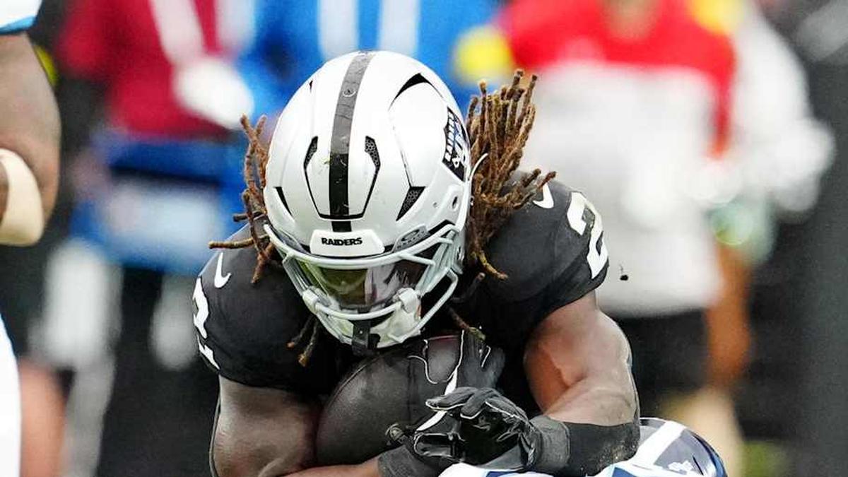  Oct 12, 2025; Paradise, Nevada, USA; Las Vegas Raiders running back Ashton Jeanty (2) runs the ball against Tennessee Titans cornerback L'Jarius Sneed (38) during the first half at Allegiant Stadium. Mandatory Credit: Stephen R. Sylvanie-Imagn Images | Stephen R. Sylvanie-Imagn Images 