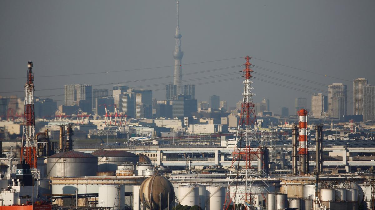 Chimneys of an industrial complex and Tokyo's skyline are seen from an observatory deck at an industrial port in Kawasaki, Japan, October 24, 2016. REUTERS/Kim Kyung-Hoon