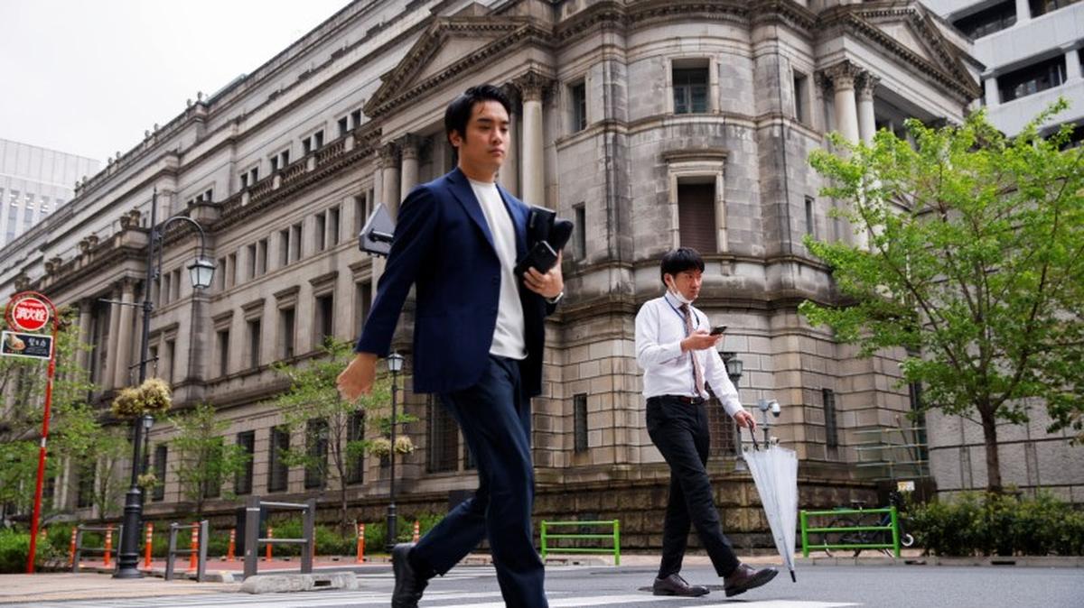 People walk in front of the bank of Japan building in Tokyo, Japan, April 7, 2023. REUTERS/Androniki Christodoulou