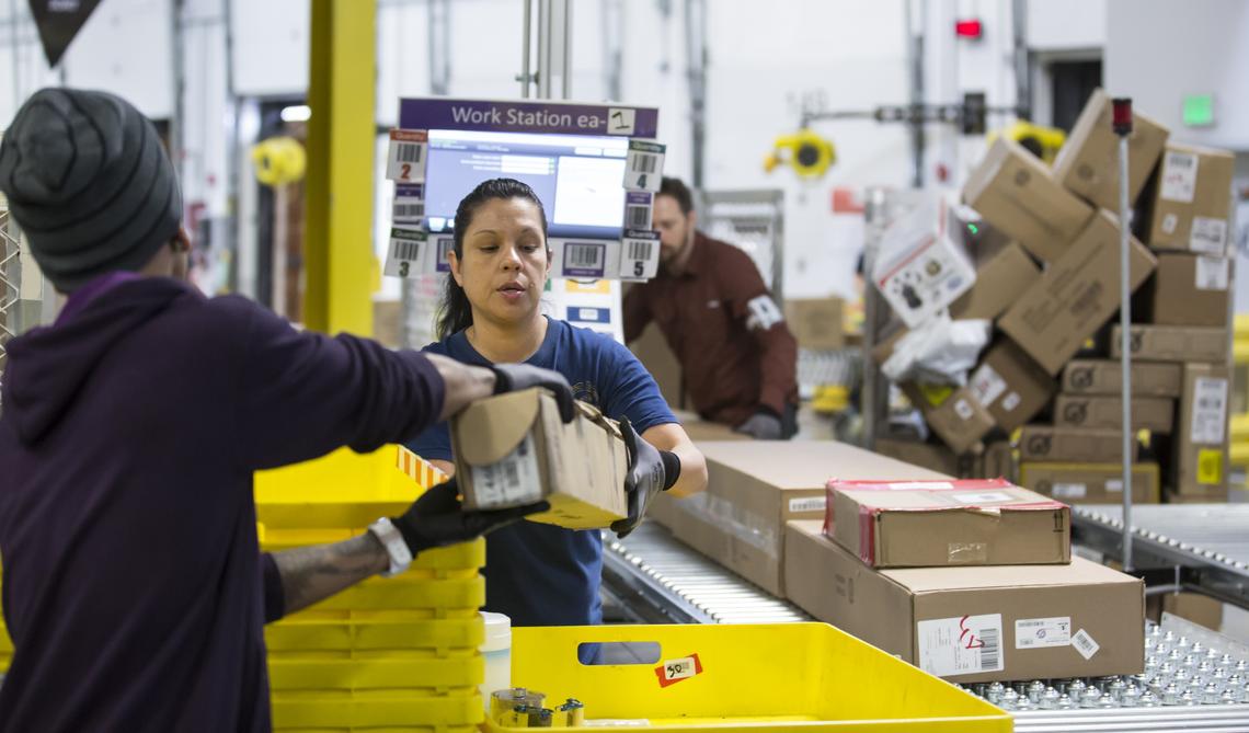  Amazon associates work at an Amazon Fulfillment Center on February 13, 2015, in DuPont, Washington. 