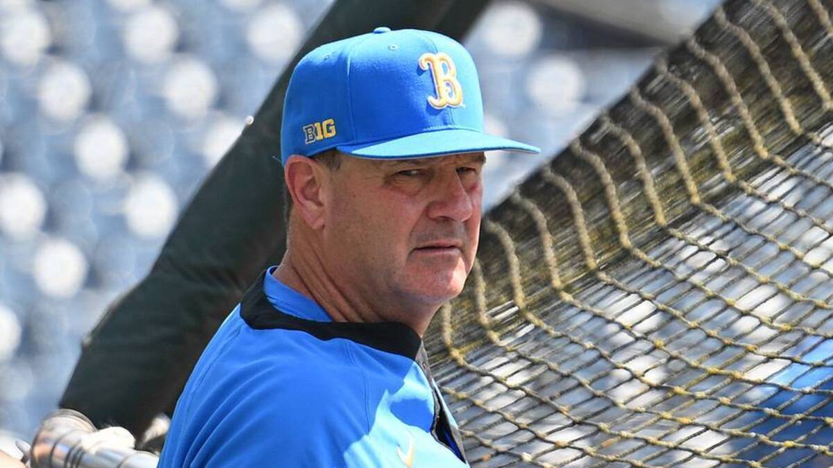  Jun 14, 2025; Omaha, Neb, USA; UCLA Bruins head coach John Savage watches the team warm up before the game against the Murray State Races at Charles Schwab Field. Mandatory Credit: Steven Branscombe-Imagn Images | IMAGN IMAGES via Reuters Connect 