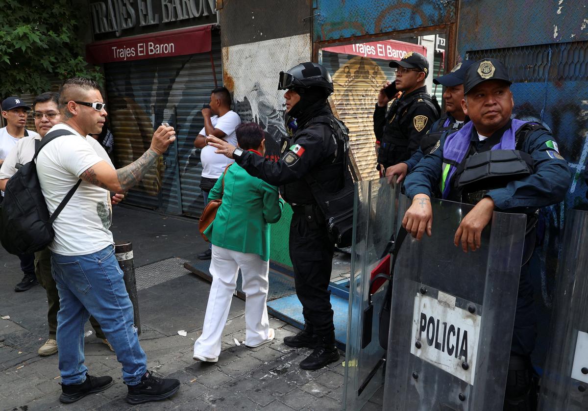 People wait to pass through a police checkpoint near the Zocalo, where dissident teachers from Mexico's National Coordination of Education Workers (CNTE) union have set up an encampment to demand higher wages and pensions, ahead of the 2026 FIFA World Cup, in Mexico City, Mexico, June 3, 2026. REUTERS/Luis Cortes