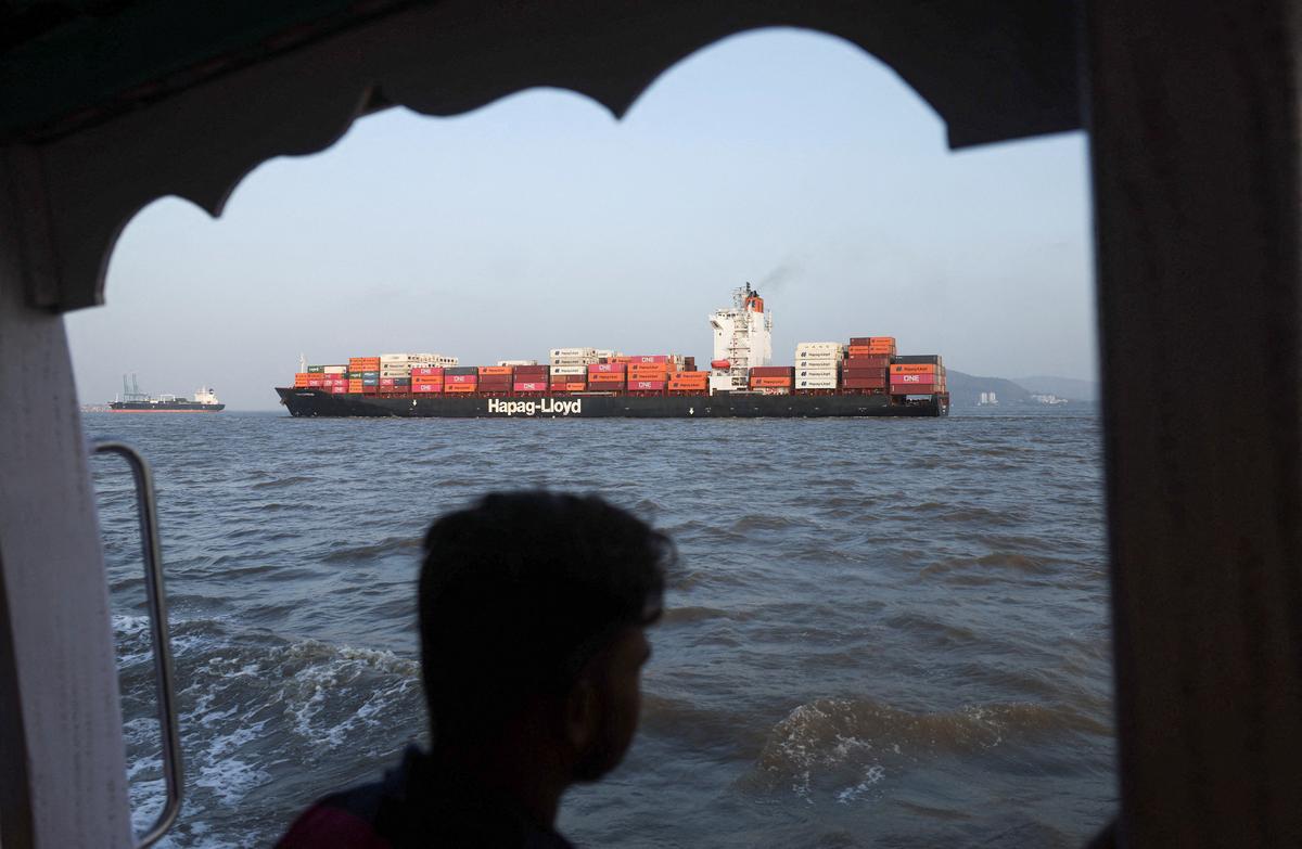 A man looks at a container ship in the Arabian Sea off the coast of Mumbai, India, May 6, 2026. REUTERS/Francis Mascarenhas
