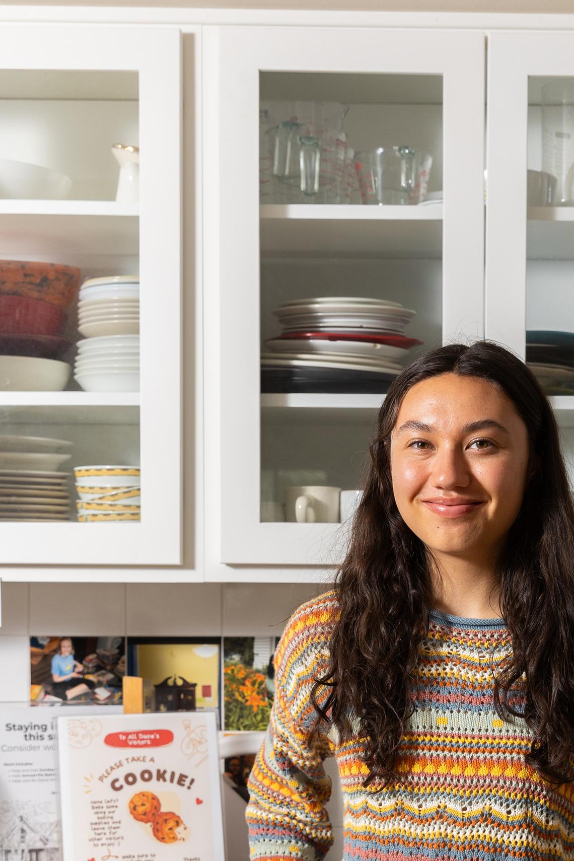Megan Roesler, a senior, with a plate of cookies at the Dacie Moses House, Carleton College's cookie house in Northfield, Minn., March 30, 2026. For decades, Carleton College has kept a place where students and others can come, bake and share. (Liam James Doyle/The New York Times)