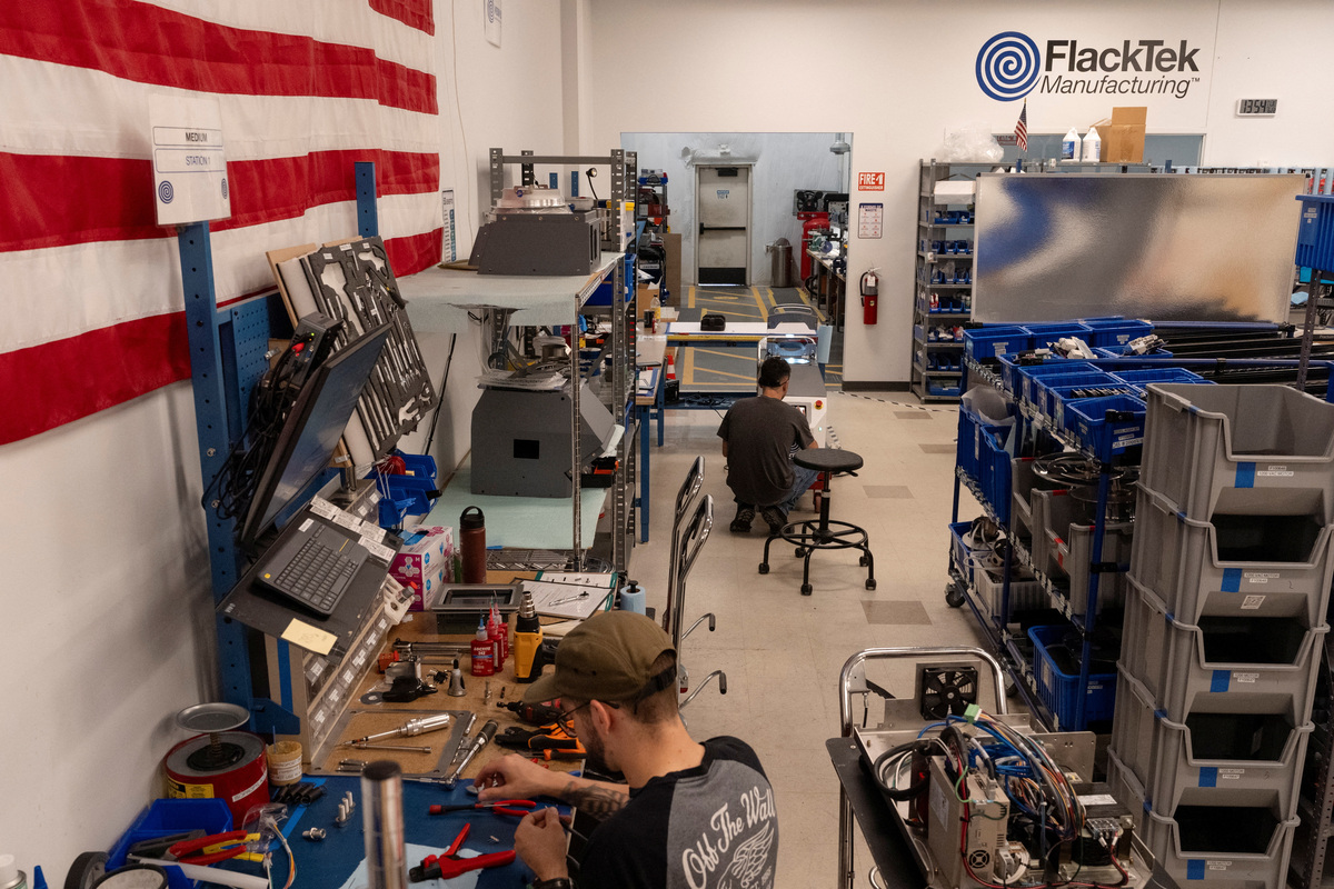 Assembly technicians work at FlackTek, a company that manufactures specialized mixing equipment used to produce energetics for missiles, in Louisville, Colorado, U.S., June 23, 2026. REUTERS/Cheney Orr