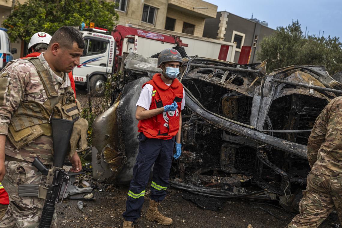 A Lebanese paramedic team, forensic investigators and Lebanese military collect evidence at the site of Israeli strikes on two vehicles along the Beirut-Saida highway, in Beirut, April 15, 2026. (Diego Ibarra Sánchez/The New York Times)