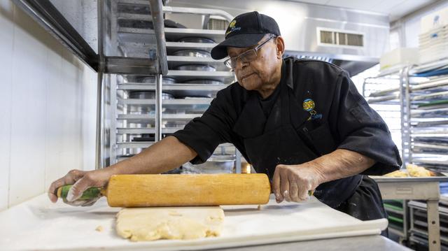 George Wright rolls out some pastry dough for making lemon bars, nut bars and raspberry bars.