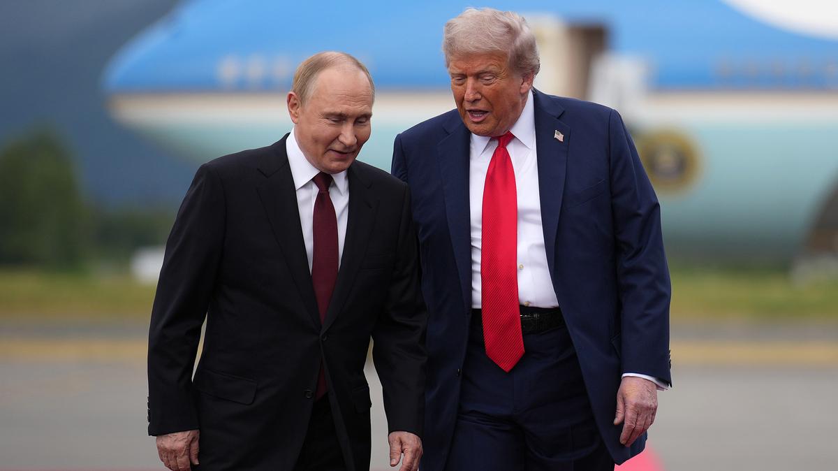 U.S. President Donald Trump, right, walks with Russian President Vladimir Putin as they arrives at Joint Base Elmendorf-Richardson on Aug. 15, 2025, in Anchorage, Alaska. 