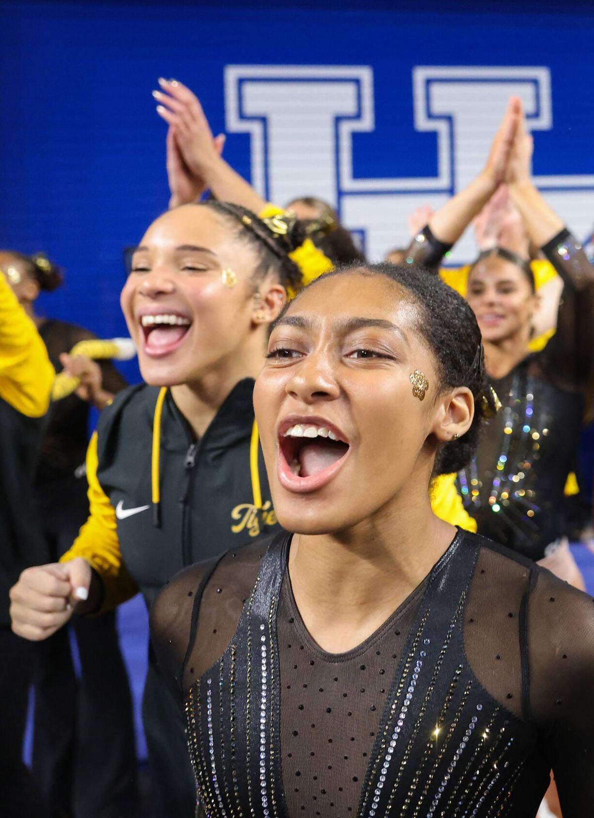 Railey Jackson, front, and Makayla Green cheer with the team as Olivia Kelly concludes her beam routine at the NCAA Lexington Regional on Friday at the Historic Memorial Coliseum in Lexington, Ky. Jackson and Kelly earned a team high of 9.850.