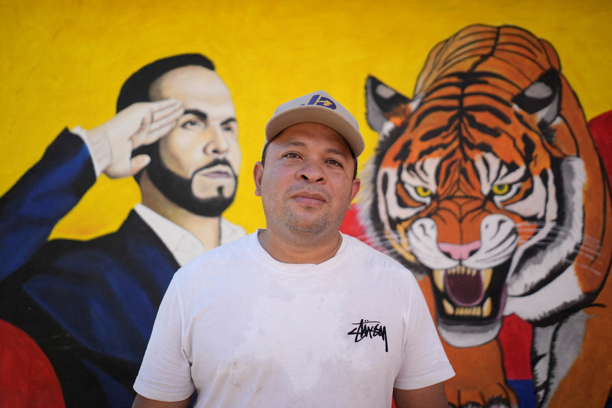 Franklin Avedano poses for a photograph in front of electoral advertisements of right-wing presidential candidate Abelardo De La Espriella, ahead of the 21 June runoff between De La Espriella and leftist candidate Ivan Cepeda, in Juan de Acosta, Colombia, June 11, 2026. REUTERS/Charlie Cordero