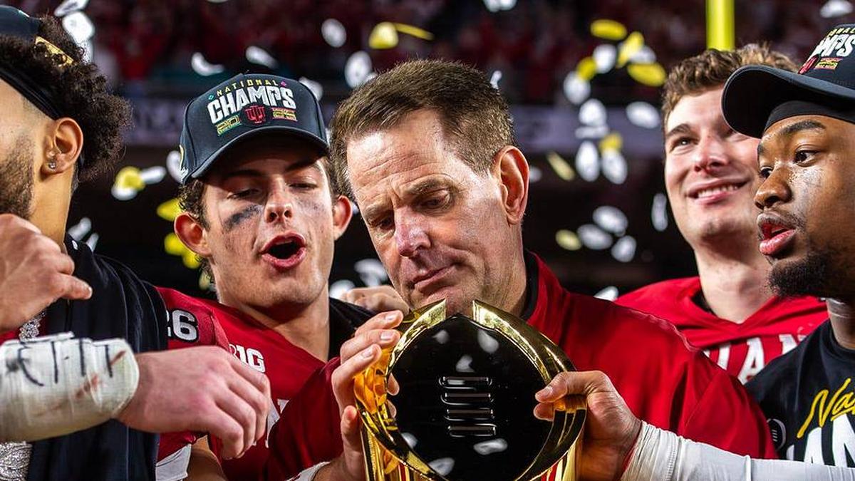  Indiana Head Coach Curt Cignetti prepares to lift the trophy on the podium after the College Football Playoff National Championship college football game at Hard Rock Stadium in Miami Gardens on Monday, Jan. 19, 2026. | Rich Janzaruk/Herald-Times / USA TODAY NETWORK via Imagn Images 