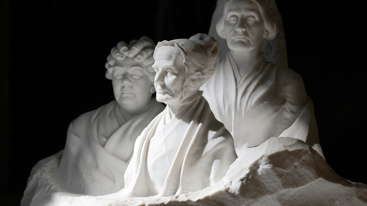 Sunlight falls on the sculpture of Elizabeth Cady Stanton, Susan B. Anthony and Lucretia Mott, the founders of the women's suffrage movement, inside the U.S. Capitol Rotunda during the ongoing federal government shutdown on Oct. 03, 2025, in Washington, DC. The federal government shut down early Wednesday after Congress and the White House failed to reach a funding deal. (Chip Somodevilla/Getty Images/TNS)