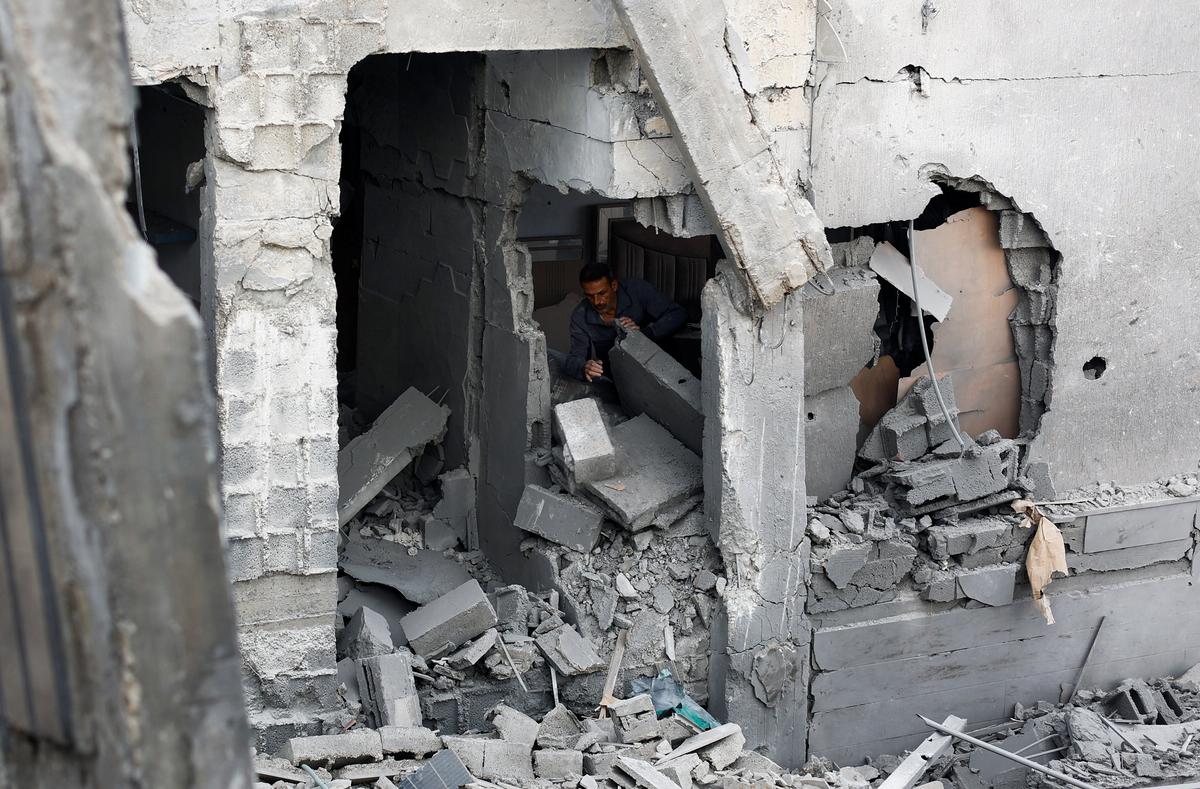 A Palestinian man inspects the site of an Israeli airstrike on a residential building on Tuesday, in Gaza City, May 27, 2026. REUTERS/Mahmoud Isaa
