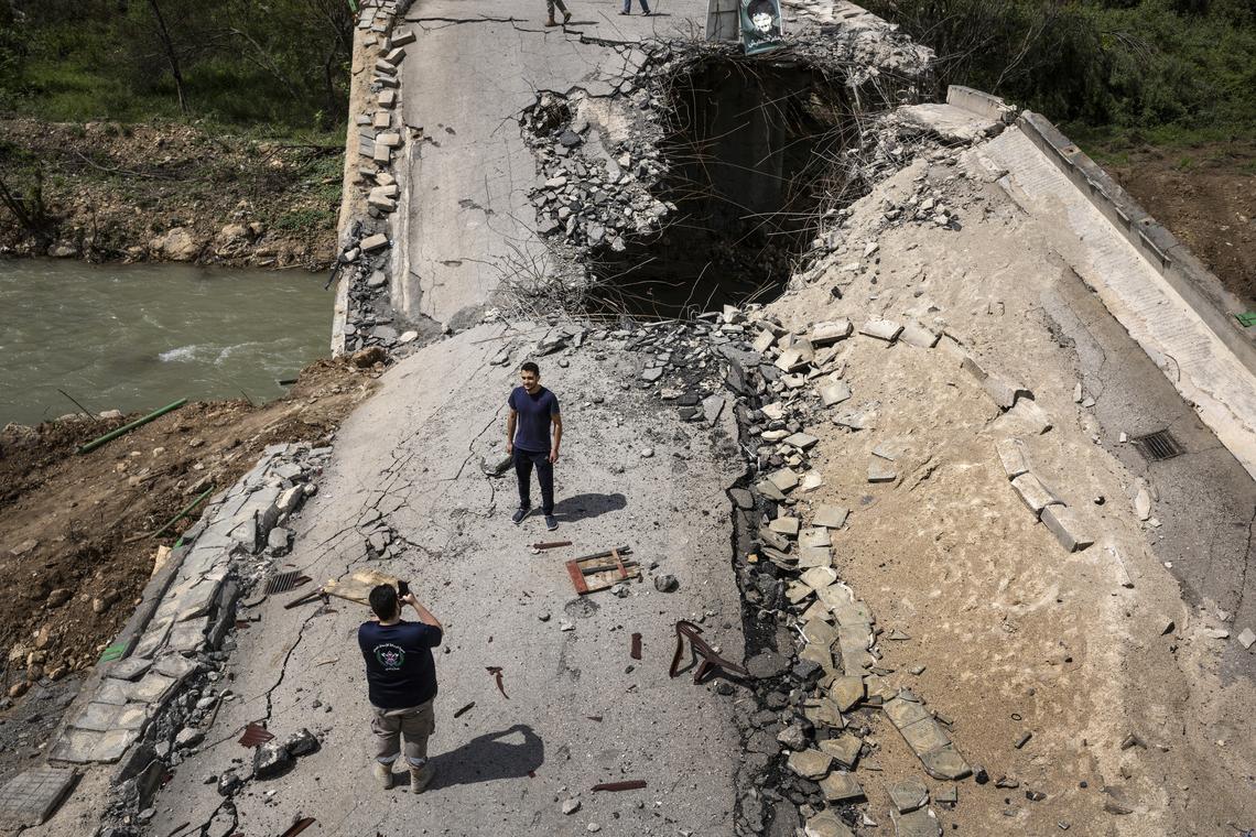 Men stop to photograph a bridge, which was destroyed by an Israeli airstrike before a recent ceasefire, over the Litani River near the village of Tayr Felsay in southern Lebanon, on Monday, April 20, 2026. The Lebanese president said he had appointed a former ambassador to the United States to lead talks aimed at ending war with Israel and achieving a complete Israeli withdrawal from southern Lebanon. (David Guttenfelder/The New York Times)