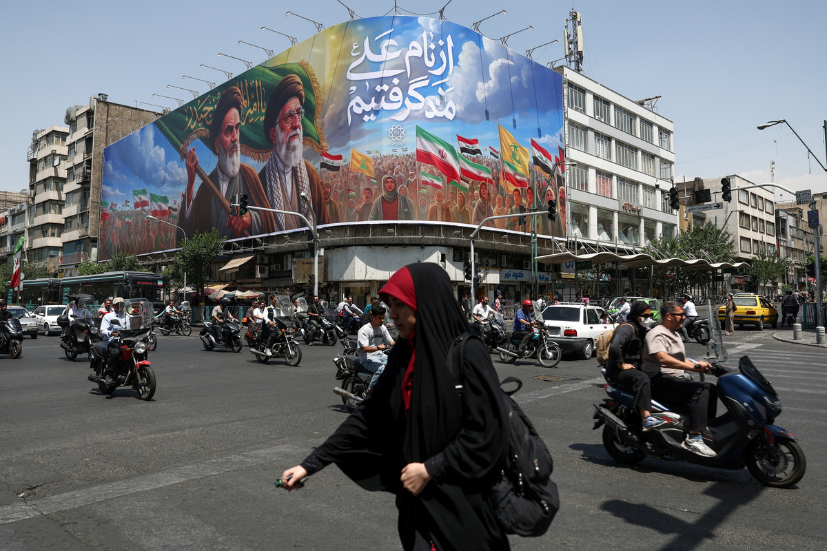 People ride past a billboard depicting the late leader of the Islamic Revolution, Ayatollah Ruhollah Khomeini, and the late Iran's Supreme Leader Ayatollah Ali Khamenei, on a street in Tehran, Iran June 6, 2026. Majid Asgaripour/WANA (West Asia News Agency) via REUTERS