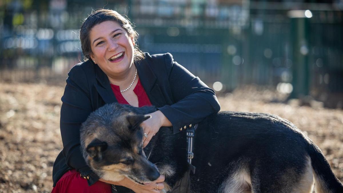 Staycee Dains, former head of L.A. Animal Services, pets a dog at Long Beach dog park in 2024.