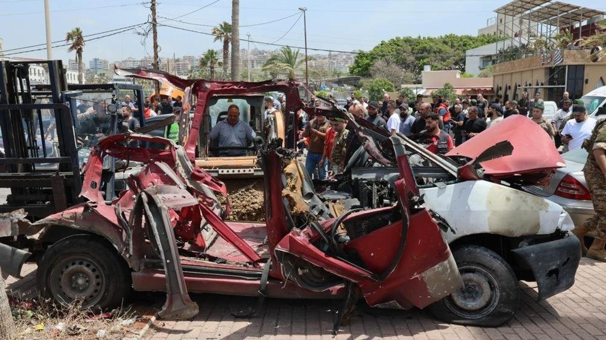  Lebanese rescuers and army soldiers inspect the wreckage of a vehicle that was hit in an Israeli strike in the southern coastal city of Sidon, Lebanon, on Wednesday. Photo by Wael Hamzeh/EPA