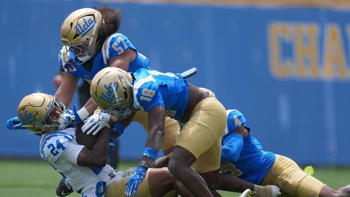  May 2, 2026; Pasadena, CA, USA; UCLA Bruins linebacker Matthew Muasau (57) and defensive backs Osiris Gilbert (18) and Cole Martin (4) tackle receiver Jonah Smith (24) during the spring game at Rose Bowl. Mandatory Credit: Kirby Lee-Imagn Images | Kirby Lee-Imagn Images 