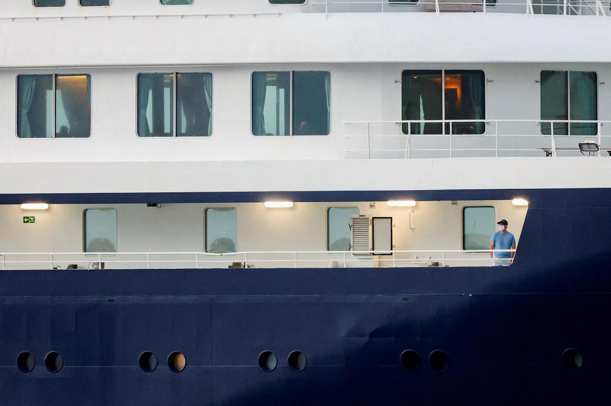 A person wearing a mask stands aboard the cruise ship MV Hondius at the port of Granadilla de Abona after being affected by a hantavirus outbreak, in Tenerife, Spain, May 10, 2026. REUTERS/Hannah McKay