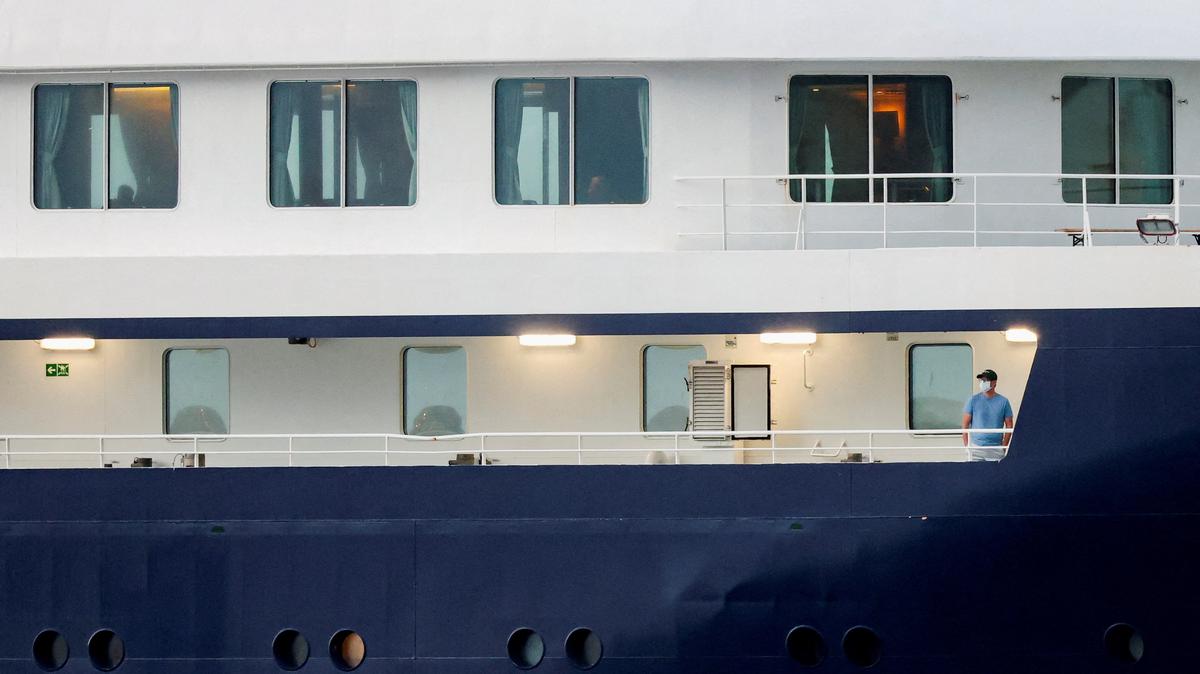 A person wearing a mask stands aboard the cruise ship MV Hondius at the port of Granadilla de Abona after being affected by a hantavirus outbreak, in Tenerife, Spain, May 10, 2026. REUTERS/Hannah McKay