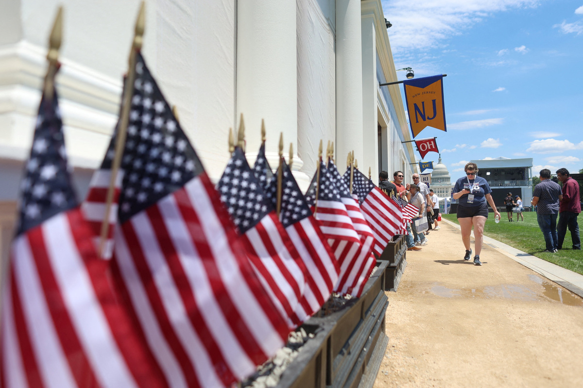 Visitors pass along state exhibits at the Great American State Fair on the National Mall in Washington, D.C., U.S., June 25, 2026. REUTERS/Tom Brenner