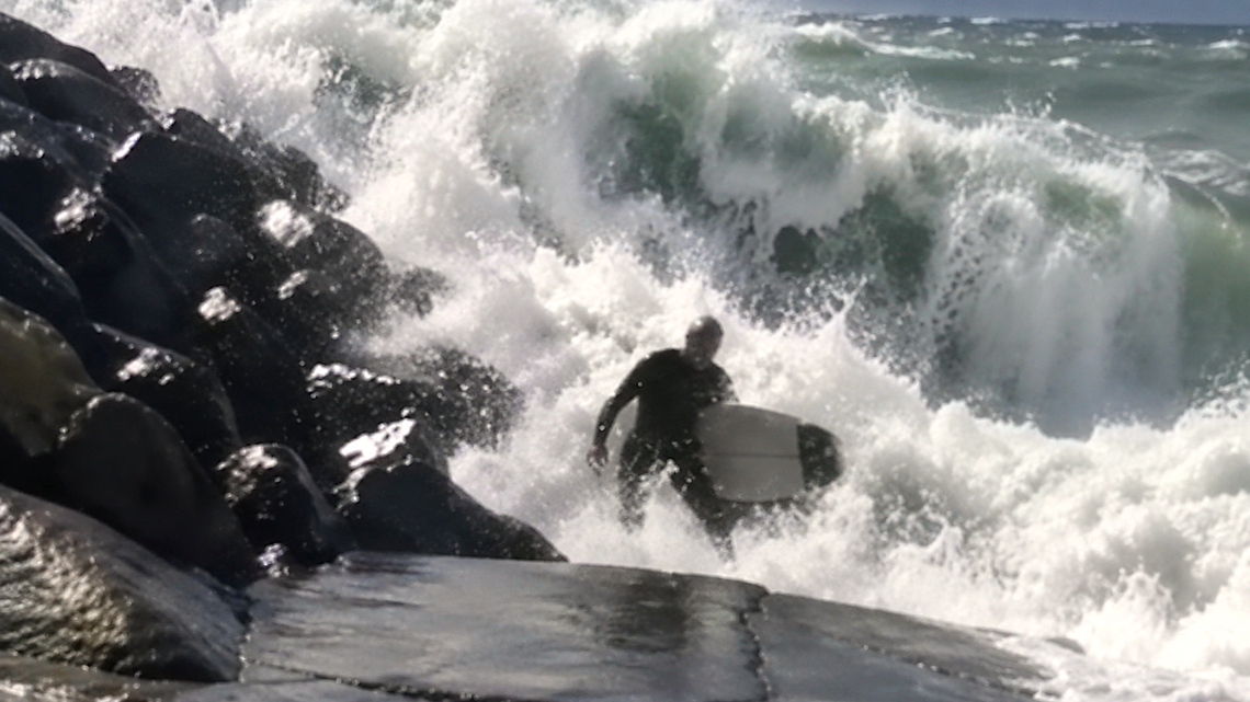 Massive Hurricane Swell Slams Surfer Into Oceanside Rocks, Knocks Him Out (Video) 