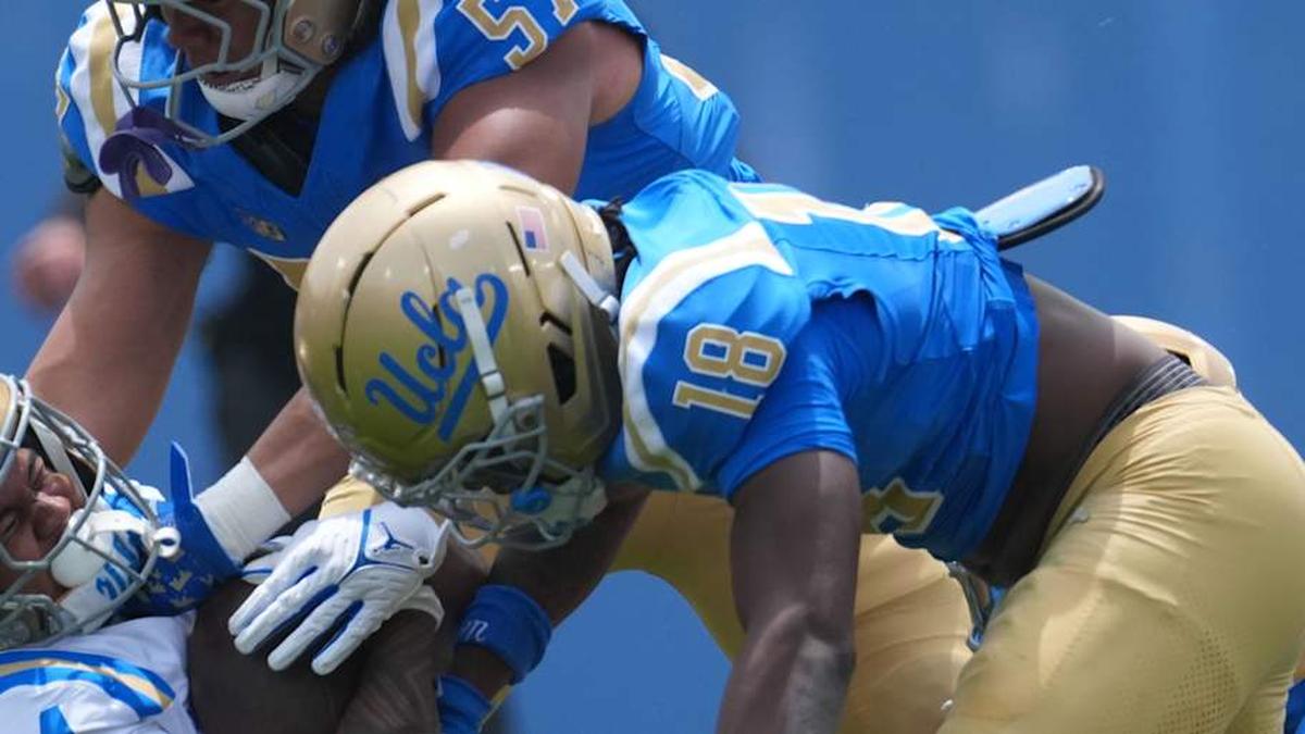 May 2, 2026; Pasadena, CA, USA; UCLA Bruins linebacker Matthew Muasau (57) and defensive backs Osiris Gilbert (18) and Cole Martin (4) tackle receiver Jonah Smith (24) during the spring game at Rose Bowl. Mandatory Credit: Kirby Lee-Imagn Images | Kirby Lee-Imagn Images 