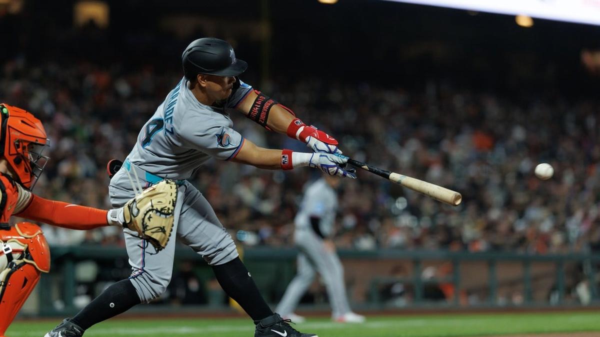 Jun 25, 2025; San Francisco, California, USA; Miami Marlins designated hitter Heriberto Hernandez (64) hits a two run RBI single during the eighth inning against the San Francisco Giants at Oracle Park. Mandatory Credit: Sergio Estrada-Imagn Images