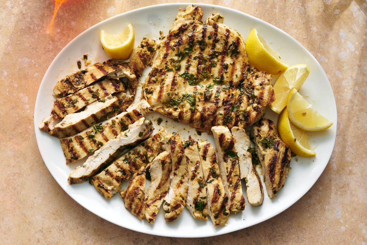 Lemon-garlic grilled chicken breasts. This smoky beauty of a recipe, with its juicy swirl of lemon and olive oil, its fragrant charred garlic and parsley, is mouthwatering in the primal way of fried drumsticks and saucy wings. Prop Stylist: Paige Hicks. Food Stylist. Simon Andrews. (David Malosh/The New York Times)