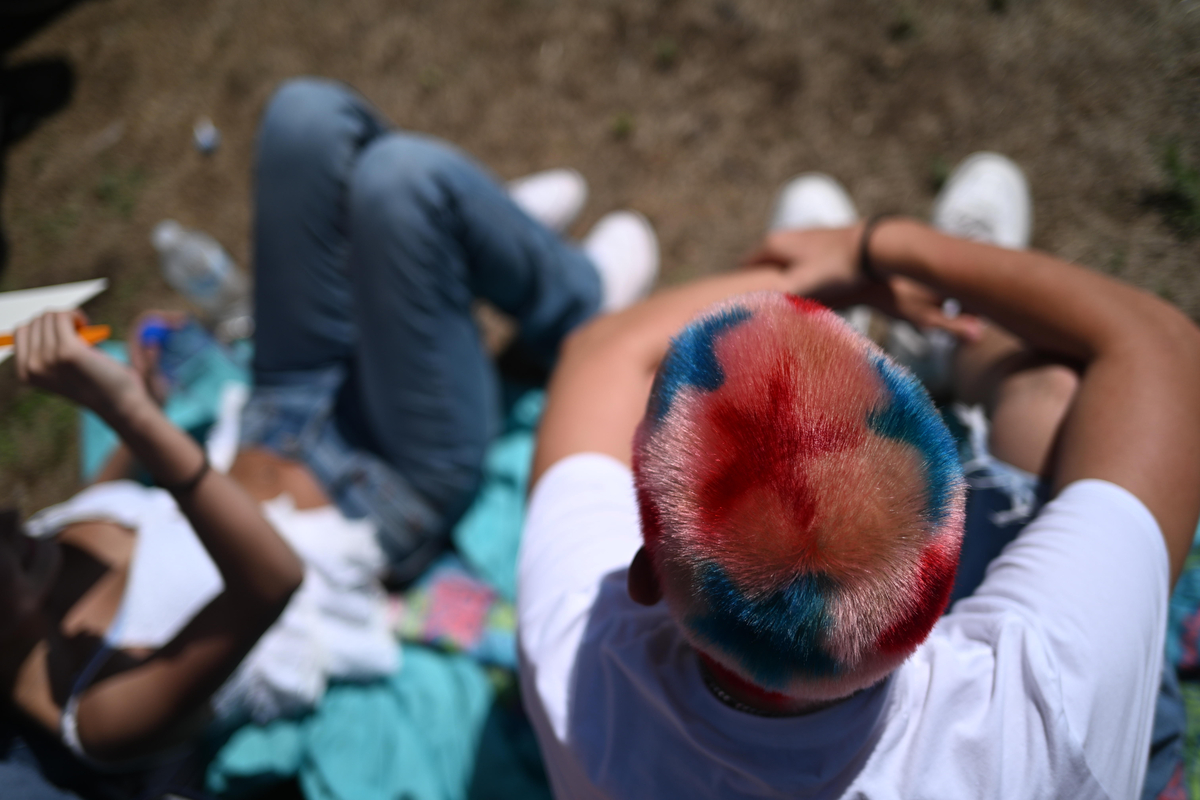 An attendee with patriotic dyed hair at the Greeley Stampede's Independence Day parade in Greeley, Colo., July 4, 2026. America celebrates the 250th anniversary of its independence today, with people from one end of the country to the other marking the milestone with fireworks, parades and concerts. (Mark Makela/The New York Times)