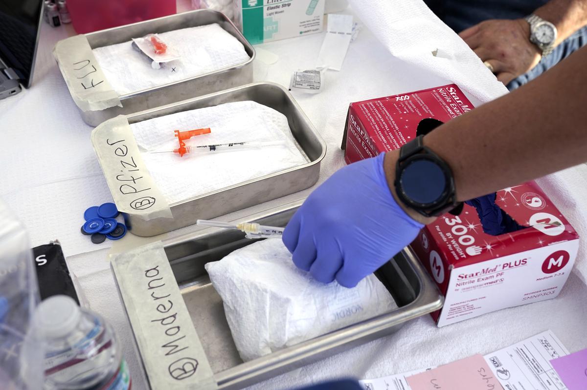  Syringes with vaccines are prepared at the L.A. Care and Blue Shield of California Promise Health Plans’ Community Resource Center, where they were offering members and the public free flu and COVID-19 vaccines on October 28, 2022, in Lynwood, California. 