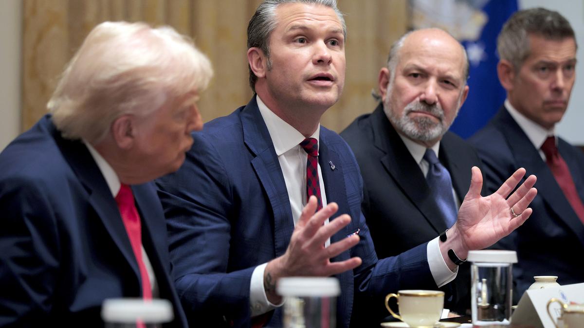 U.S. Secretary of War Pete Hegseth, center, speaks during a Cabinet meeting alongside (left to right) President Donald Trump, Secretary of Commerce Howard Lutnick and Secretary of Transportation Sean Duffy in the Cabinet Room of the White House on Dec. 2, 2025, in Washington, D.C.