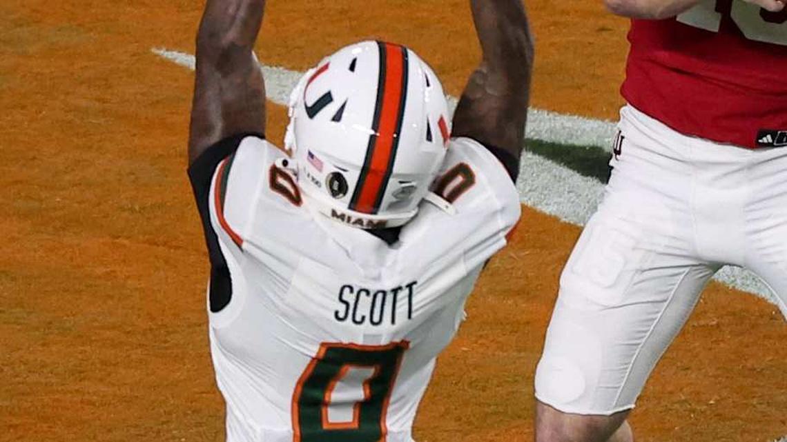  Jan 19, 2026; Miami Gardens, FL, USA; Indiana Hoosiers quarterback Fernando Mendoza (15) passes the ball under pressure by Miami Hurricanes defensive back Keionte Scott (0) in the first quarter during the College Football Playoff National Championship game at Hard Rock Stadium. Mandatory Credit: Kim Klement Neitzel-Imagn Images | Kim Klement Neitzel-Imagn Images 