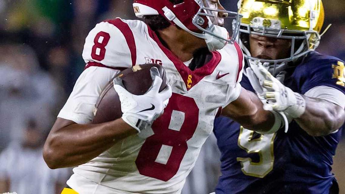  Oct 18, 2025; South Bend, Indiana, USA; Southern California Trojans wide receiver Ja'Kobi Lane (8) breaks a tackle by Notre Dame Fighting Irish safety Tae Johnson (9) during the second half at Notre Dame Stadium. Mandatory Credit: Michael Caterina-Imagn Images | Michael Caterina-Imagn Images 