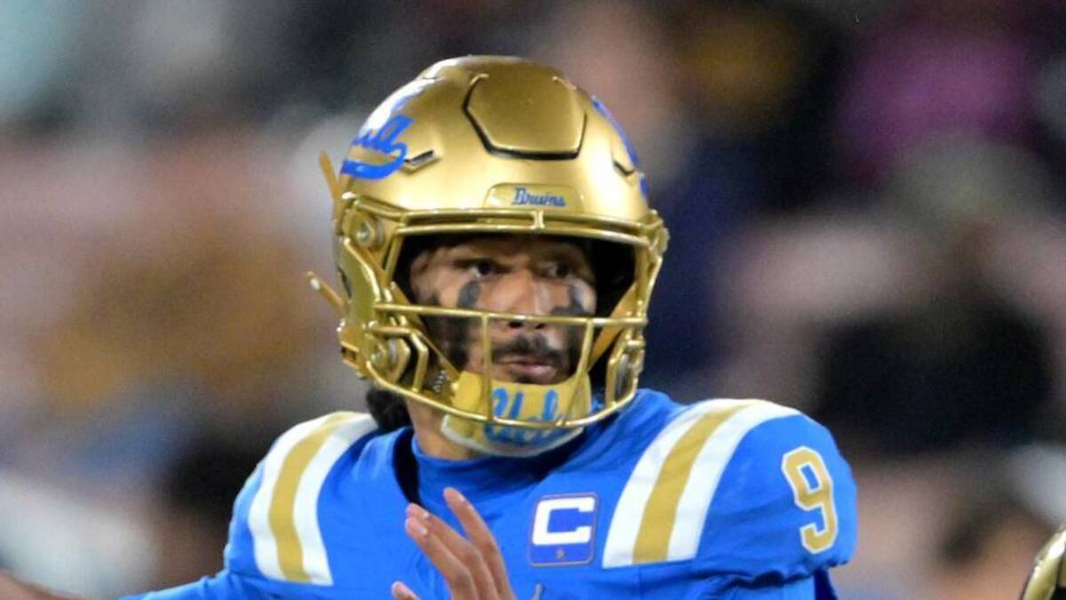  Nov 22, 2025; Pasadena, California, USA; UCLA Bruins quarterback Nico Iamaleava (9) is pressured by Washington Huskies linebacker Zach Durfee (5) during the first half at the Rose Bowl. Mandatory Credit: Jayne Kamin-Oncea-Imagn Images | Jayne Kamin-Oncea-Imagn Images 
