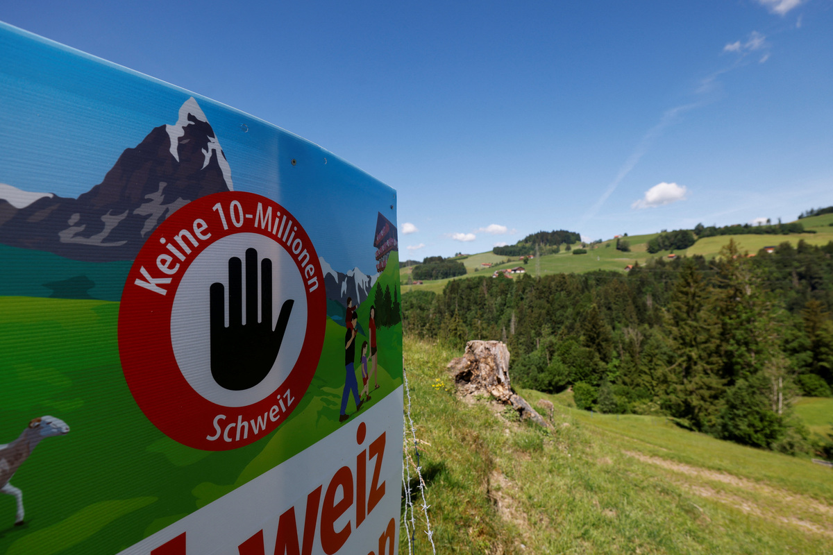 A sign sits in a field, on the day of the vote on a plan backed by the right-wing Swiss People's Party (SVP) to limit population growth to 10 million inhabitants, near Hundwil, Switzerland, June 14, 2026.  REUTERS/Michaela Stache