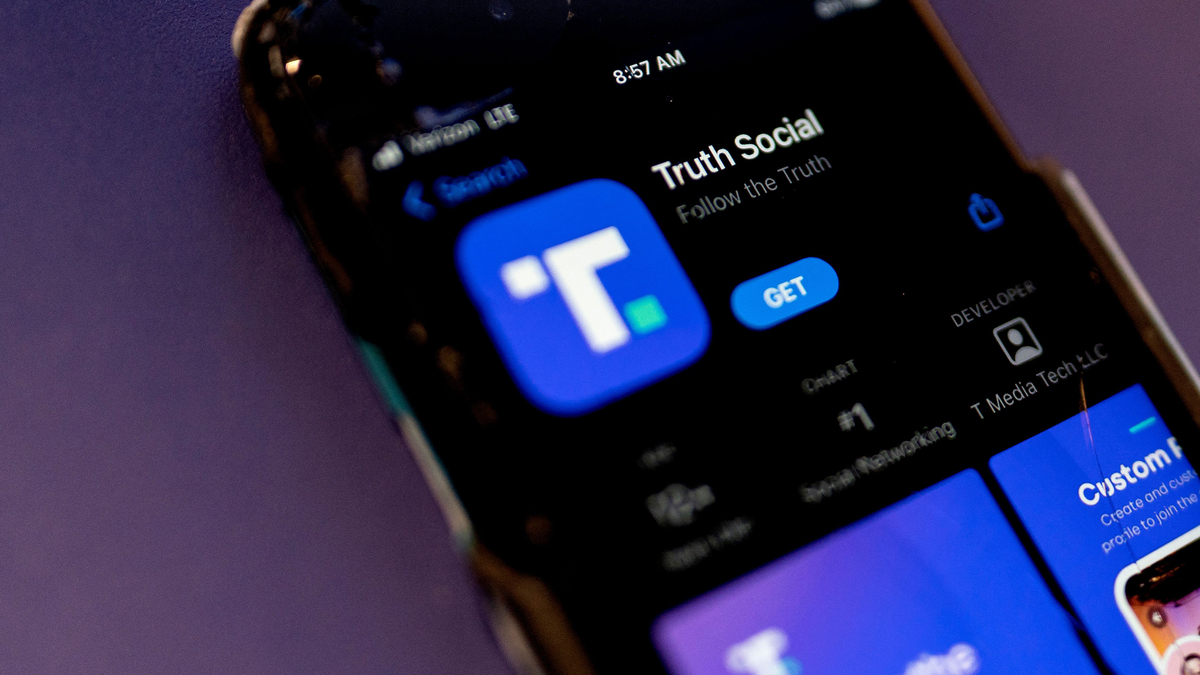 A phone screen displays the Truth Social app in Washington, D.C., on Feb. 21, 2022. President Donald Trump warned Iran that the U.S. military would “completely decimate and destroy all areas” of the Islamic Republic if its leaders attempted or carried out his assassination.The president’s message came in a Truth Social post late Friday, July 10, 2026. (Stefani Reynolds/AFP/Getty Images/TNS)