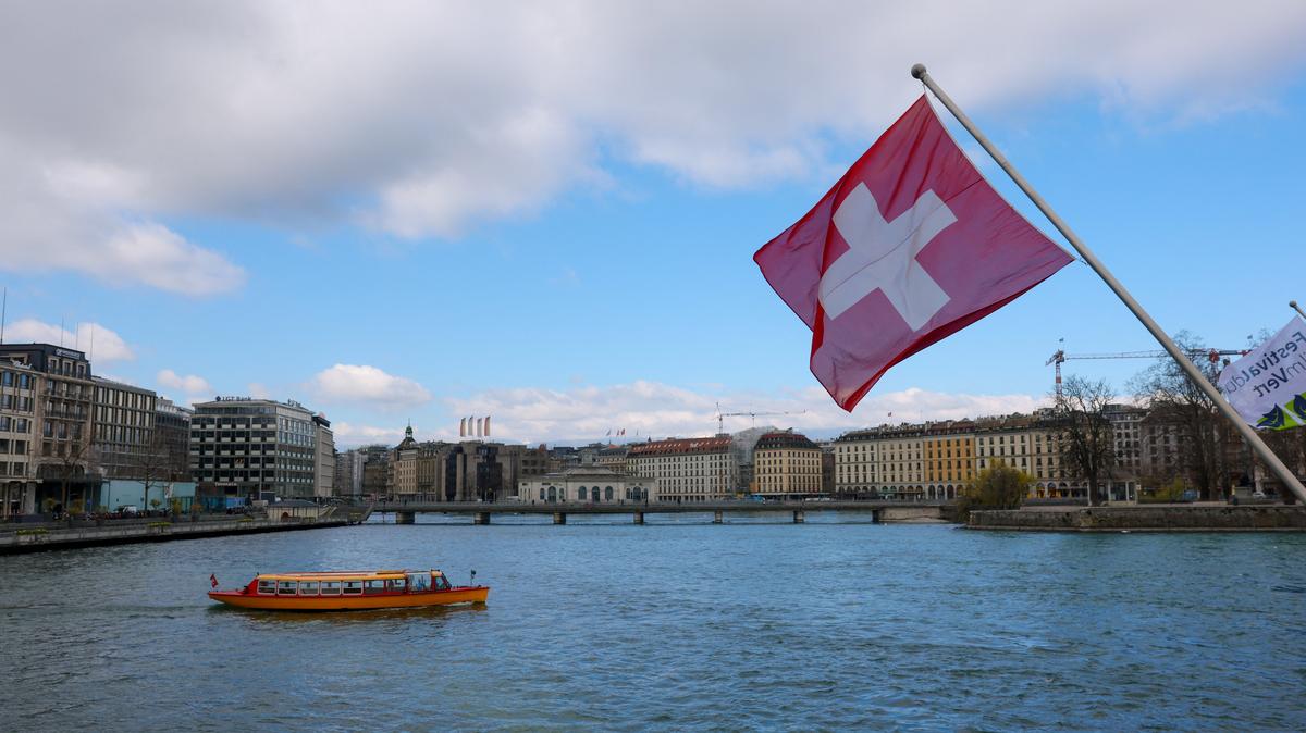 A Swiss flag and a mouette boat, as seen from the Mont Blanc bridge, in Geneva, Switzerland, March 18, 2026. REUTERS/Denis Balibouse