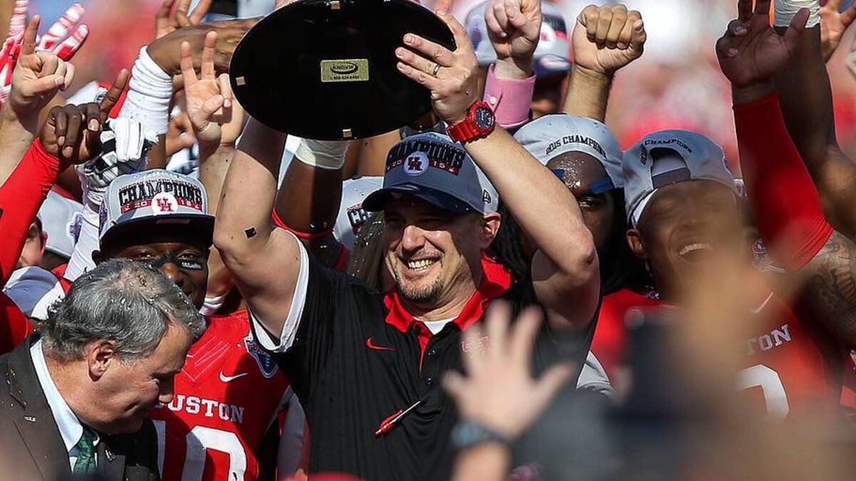  Dec 5, 2015; Houston, TX, USA; Houston Cougars head coach Tom Herman holds the Mid-American Conference football championship trophy after the Cougars defeated the Temple Owls 24-13 at TDECU Stadium. Mandatory Credit: Troy Taormina-USA TODAY Sports | IMAGN IMAGES via Reuters Connect 