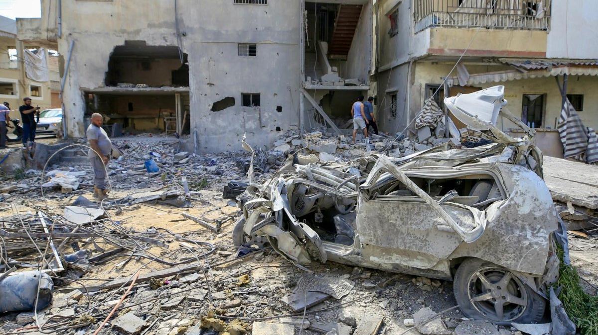 Residents of Tyre pore over the site of Israeli airstrike on the southern port city on Tuesday. Photo by Stringer/EPA