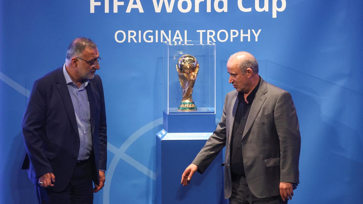 FILE PHOTO: President of Iran Football Federation Mehdi Taj and Mayor of Tehran Alireza Zakani stand next to the FIFA World Cup Trophy during an unveiling ceremony in Tehran, Iran September 1, 2022.  Majid Asgaripour/WANA (West Asia News Agency) via REUTERS/ File Photo